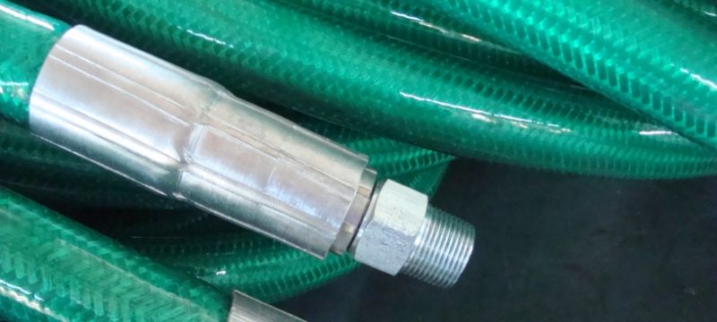Many polymer armoured hoses are placed on the ground.